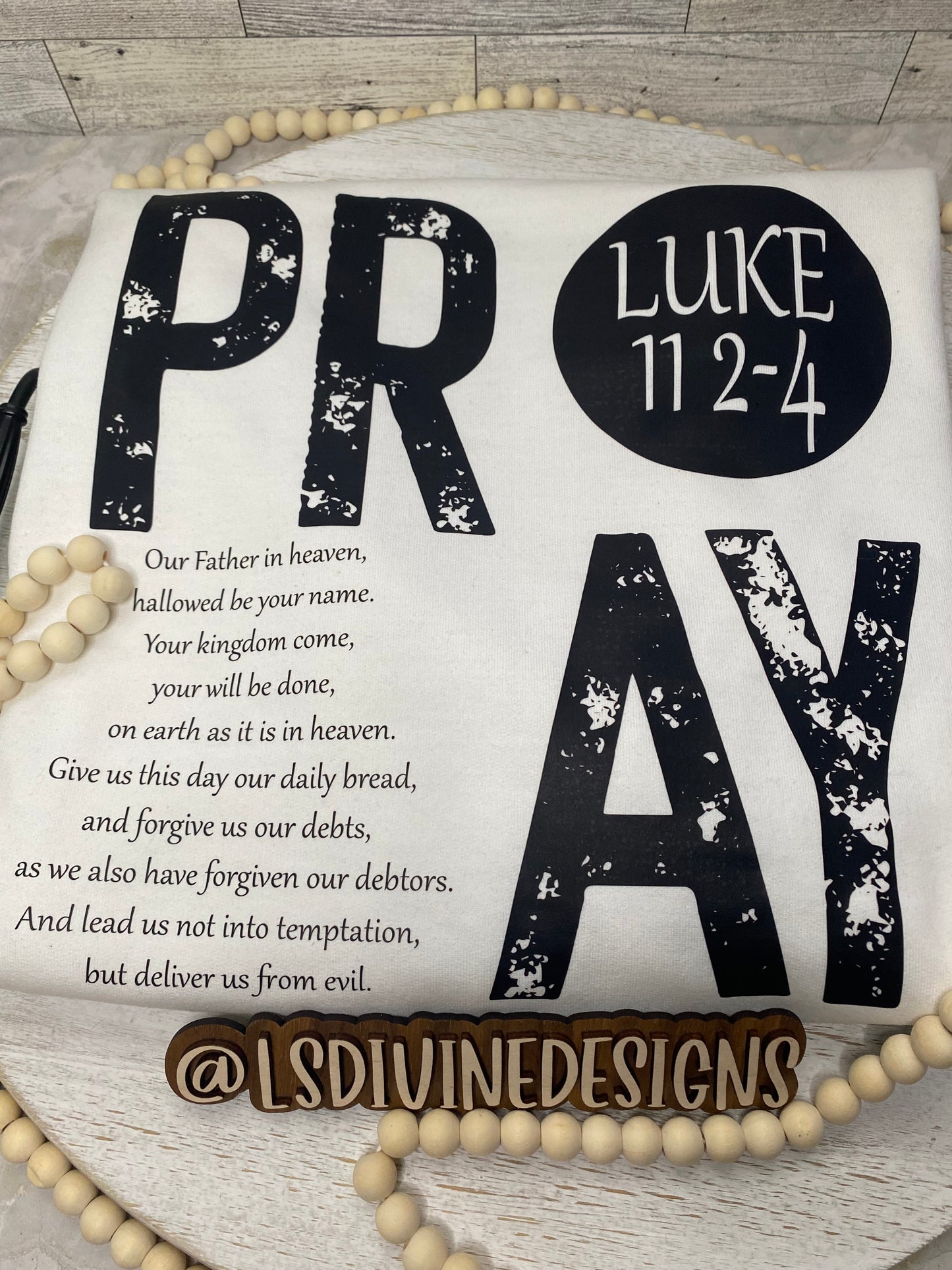 “The Lord’s Prayer” on the back of the sweatshirt