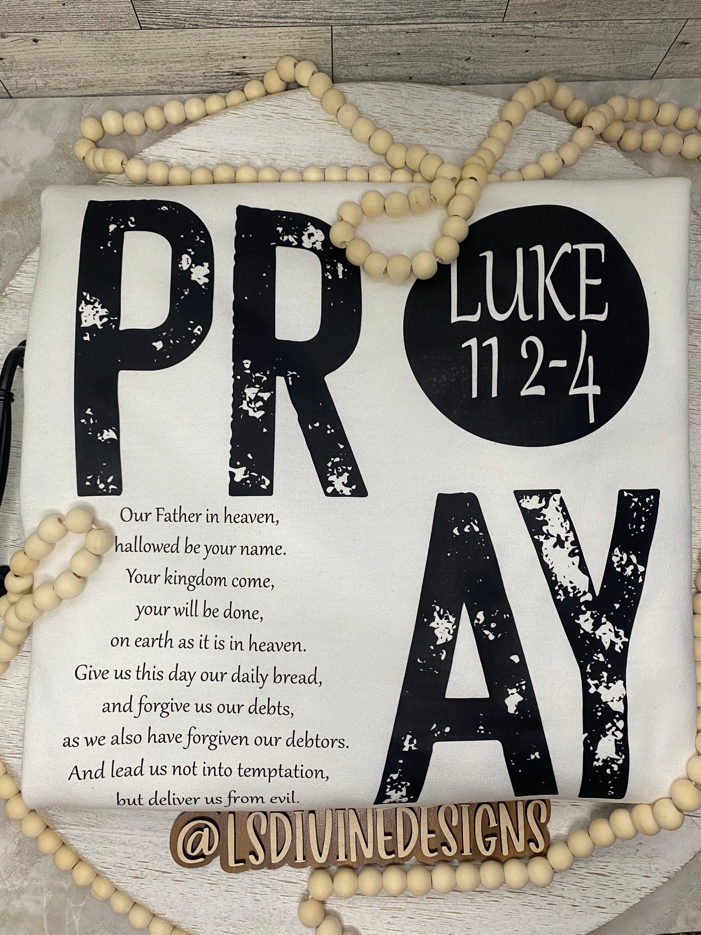 “The Lord’s Prayer” on the back of the sweatshirt