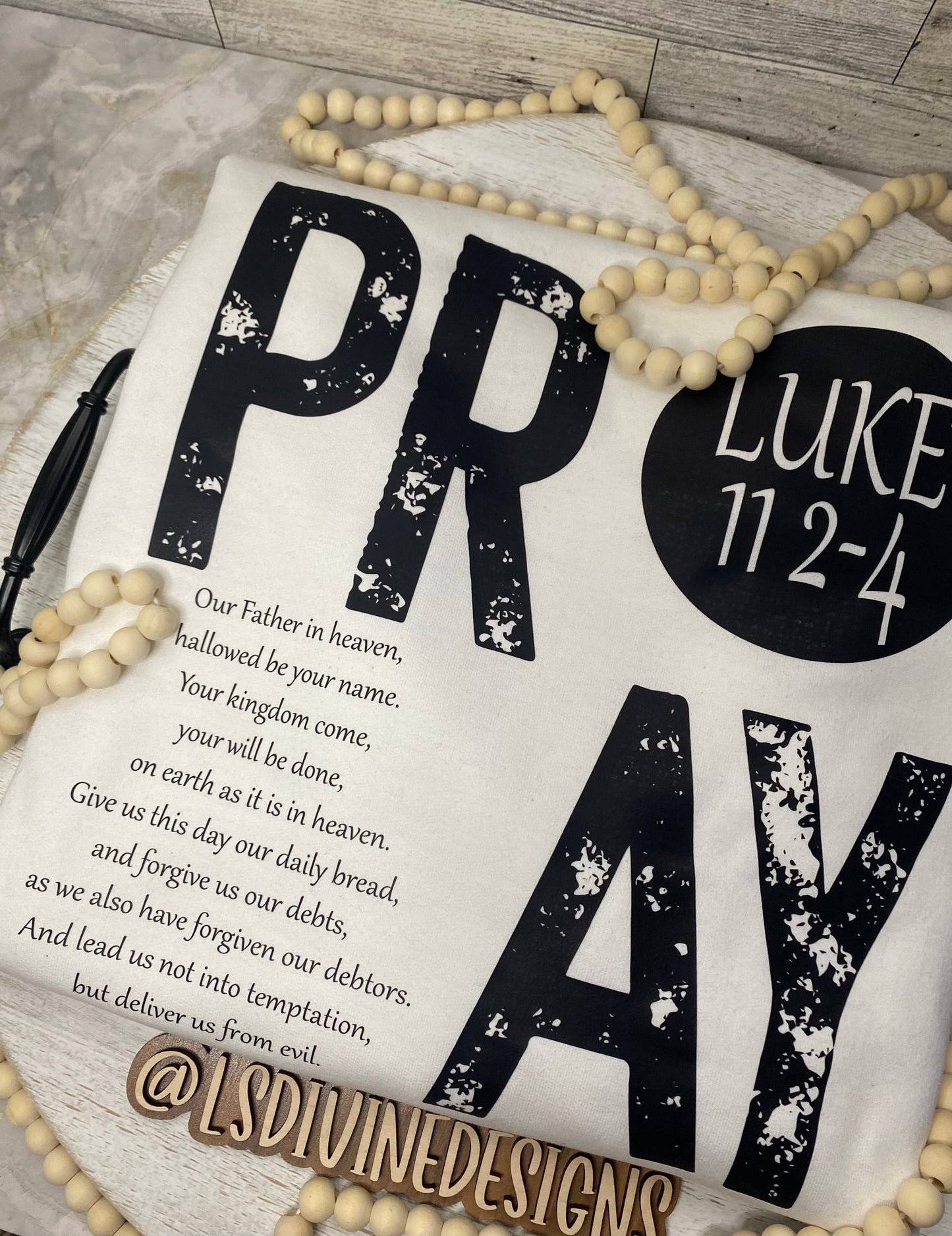 “The Lord’s Prayer” on the back of the sweatshirt