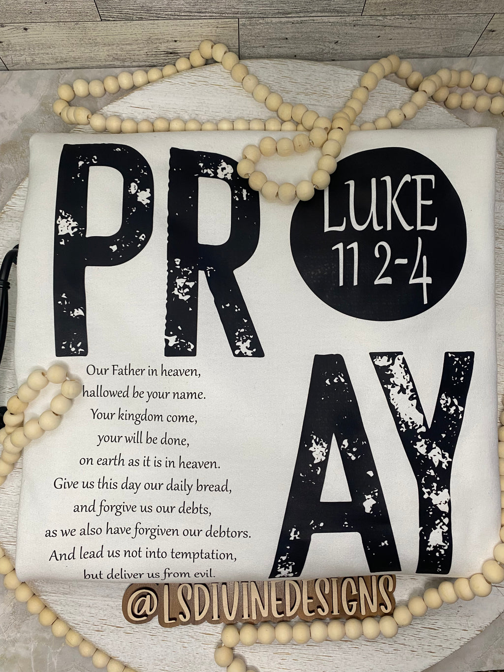 “The Lord’s Prayer” on the back of the sweatshirt