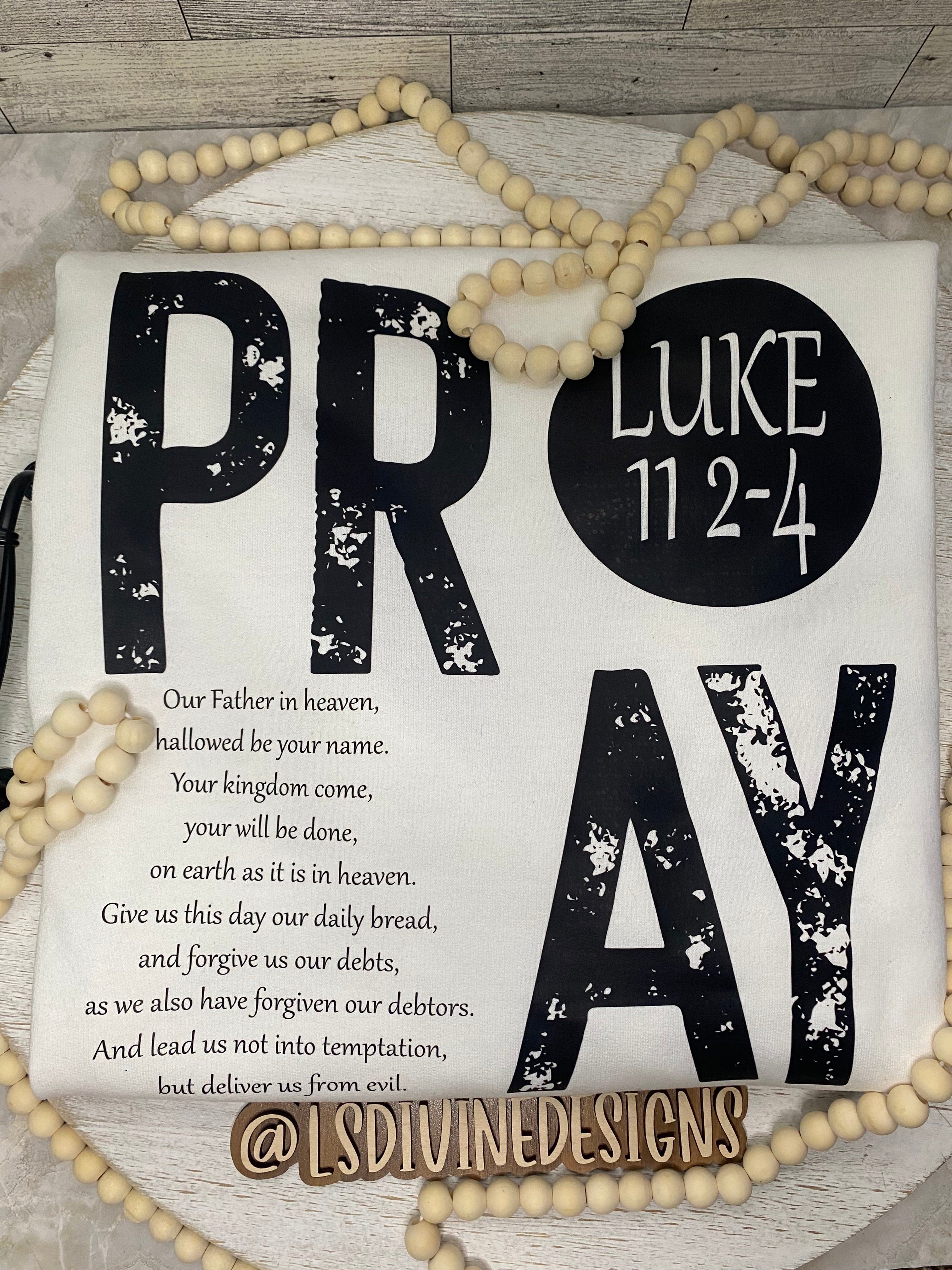 “The Lord’s Prayer” on the back of the sweatshirt